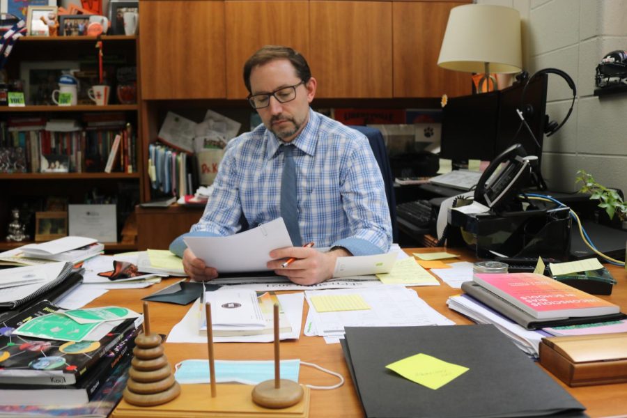 Dr. K is deep in thought in his office where he works hard everyday to decide upon community concerns, utilizing the DARING mission statement of D128 (which encourages unity and inclusivity) for the best interests of students and staff.