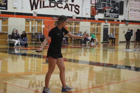 Senior Sydney Cooper serves a long and deep underhand towards her opponent.