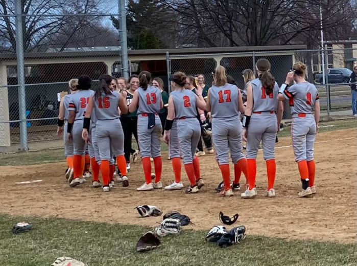 LHS' varsity girls softball team exchanges high-fives with Crystal Lake at the end of the game