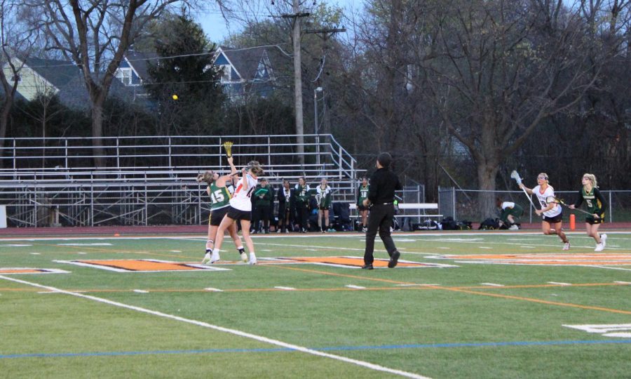 The game has begun! Sophia Weick, sophomore, and Stevenson player, 15, fight to win the ball from the draw.