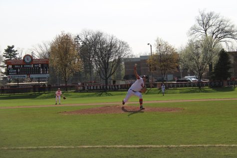 Connor Walters takes a long stride towards home as he delivers his pitch.
