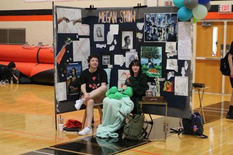 AP Art students set up their booths with candy, pins, chairs, and decorations to make their spaces more inviting and to share their art with people.