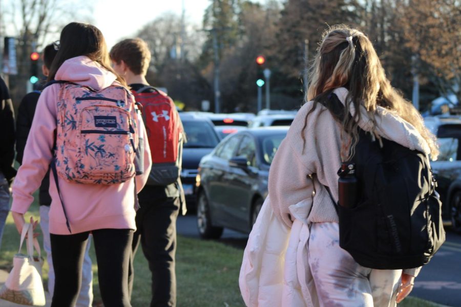 Freshman hike home after a long day with heavy backpacks. According to experts, excess weight such as carrying a backpack for several hours a day can lead to mild health conditions later in life.