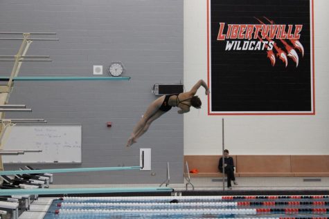 Junior Bella Mazza performing a back one somersault with one and half twist. Mazza is the only member of the team that knows how to accomplish this dive. 