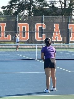 Sophomore Dakota Olsen, number two for singles on the girls’ tennis varsity, serves to the opposing team at the Libertyville High School tennis courts. 
