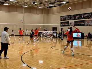 Senior Keira Kasten sets up for a powerful serve during the game against New Trier.