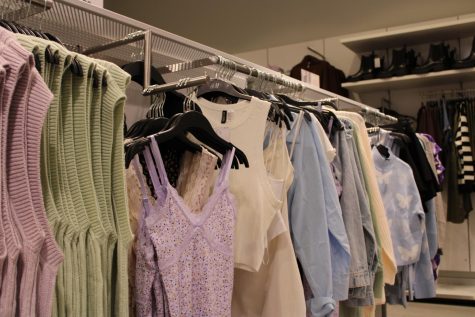 A display at H&M is filled with popular trends at the moment, such as sweater vests, slip dresses, and oversized button downs. Most likely, in a couple weeks the items displayed today will be on the sales rack because of the accelerated trend cycle, which causes pieces to rise and decline in popularity at a faster rate. 