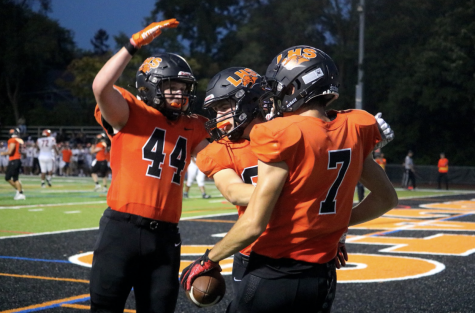 Seniors Jacob Dinklenburg (44) and Antonio Oliverii (80) congratulate Kristian Gavric (7) on his third touchdown of the night in the endzone. The team morale was high as Gavric said, “Everyone was a lot more confident, after taking the loss last week to a good team nobody was really satisfied. So going into this game, after beating them last year, we had a lot more confidence to come onto our home field and win”.