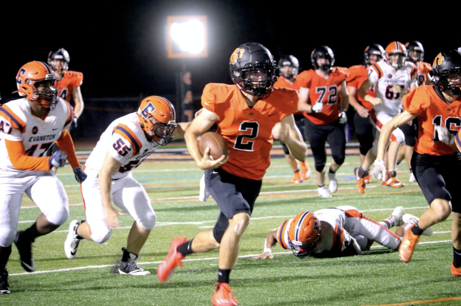 Senior Rocco LaVista (2) sprints from the 30-yard-line, defended by his teammates alongside him. He carried the ball to the endzone making the student section roar with excitement, as well as leading the entire football team bolting to his side in order to congratulate him. 