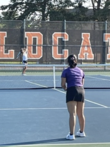 Sophomore Dakota Olsen, number two for singles on the girls’ tennis varsity, serves to the opposing team at the Libertyville High School tennis courts. 