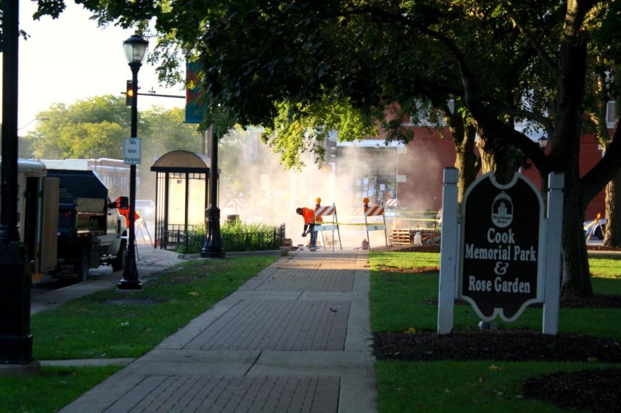 In the morning a worker focuses on rebuilding the curb across from Conscious Cup Coffee Roasters. Construction work is completed early so that the people walking during the day are not affected by any hazards.