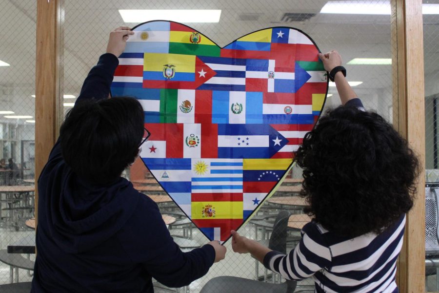 Seniors Carolina Chaves (left) and Sofia Nunes (right) display a heart with the flags of Spanish speaking countries, which The Latin American Student Organization (LASO) club used to celebrate Hispanic Heritage Month.
