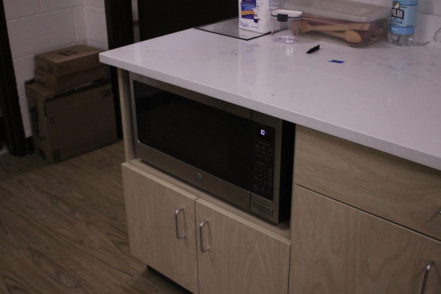 The largest difference between the ADA accessible kitchen and the other five is the placement of the microwave. Placing the microwave in the cabinets makes it accessible to use for students who have difficulty standing or reaching above their head. 
