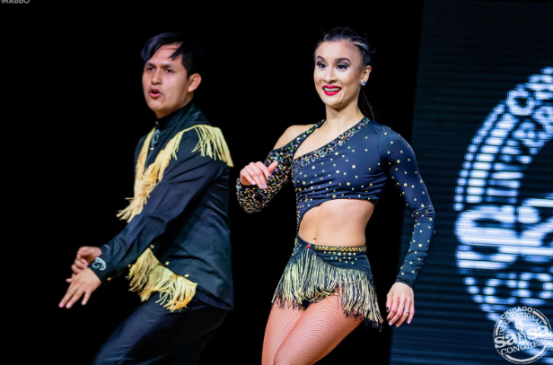 Spanish teacher Antonio Avila- Miranda salsa dances with his partner in a dancing competition.