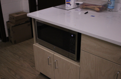 The largest difference between the ADA accessible kitchen and the other five is the placement of the microwave. Placing the microwave in the cabinets makes it accessible to use for students who have difficulty standing or reaching above their head. 