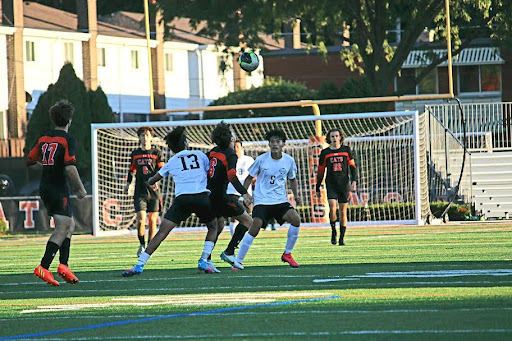 Sophomore Andrew Slago (6) and his teammates prepare to score as the ball soars overhead.