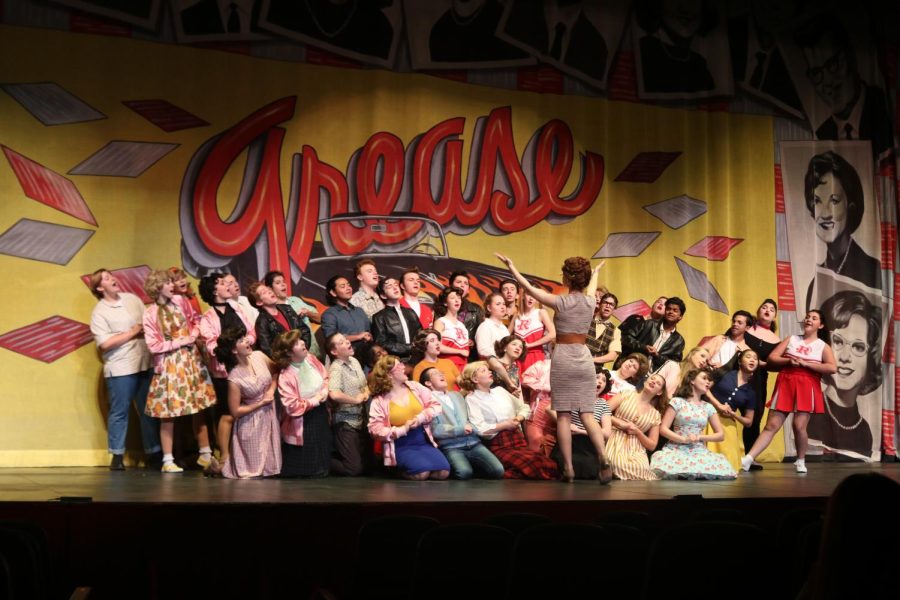 The students of Rydell High come together to sing a rendition of ‘We Go Together’. This scene kicks off the introductions of the several lovable characters of Grease where the audience will then meet their leads, Danny Zuko and Sandy Dombrowski.