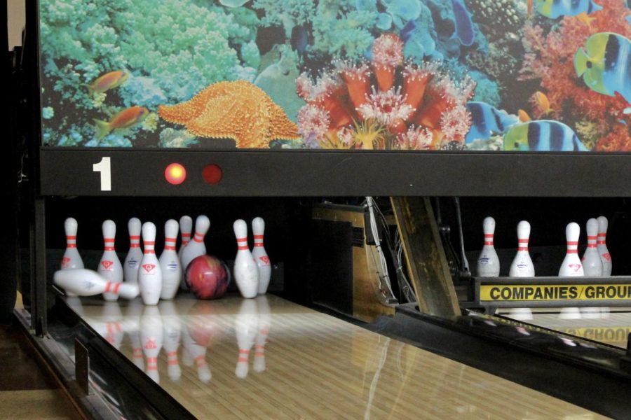 Senior Jack Campbell knocks over seven pins during warm-ups. Campbell scored the most for varsity this match, contributing a sum of 629 points.