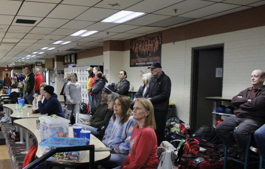 Parents observe quietly as the boys’ bowling team begins their warm-ups in preparation for the match.