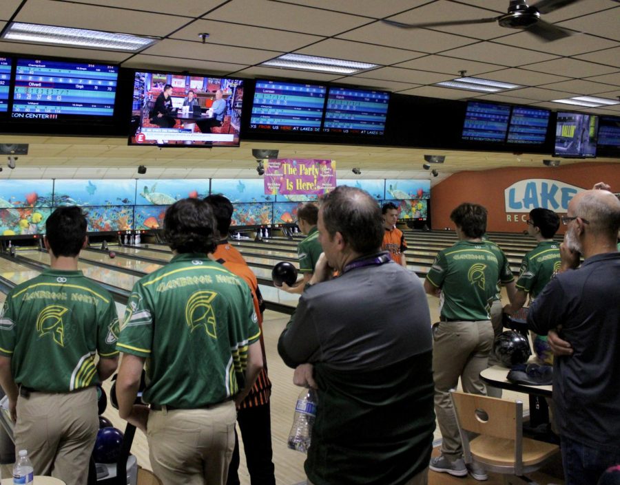 The opposing Spartans from Glenbrook North observe closely as the Wildcats step up to bowl.