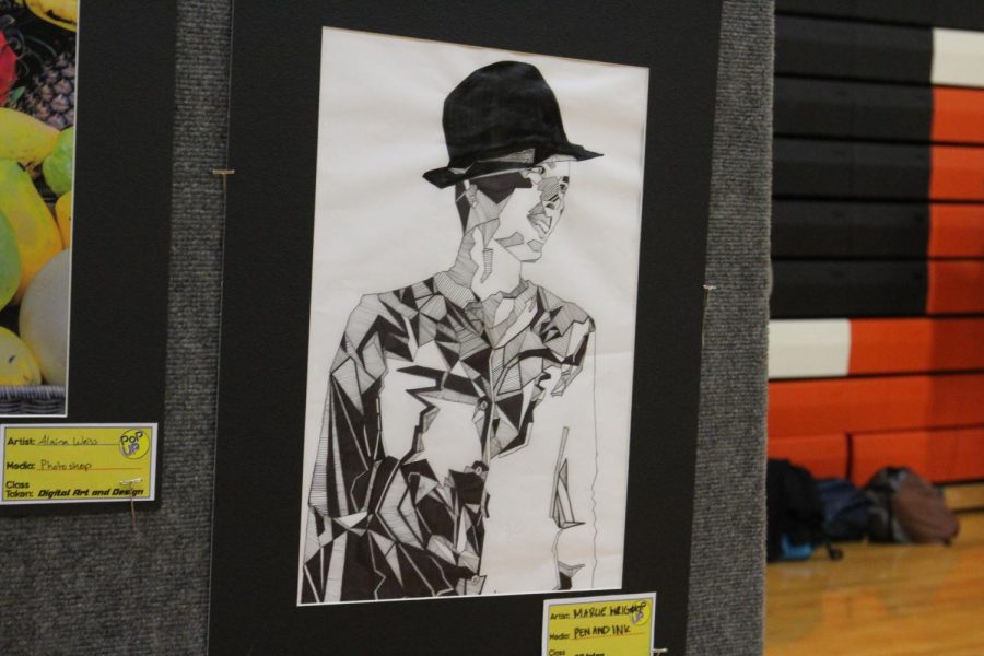“The inspiration for this piece was Mr. Gossell [shining] different lights [while we] would wear funky hats and other props,” Senior Marcie Wright, the artist, explained. She drew the piece based on the photos Gossell had taken. 