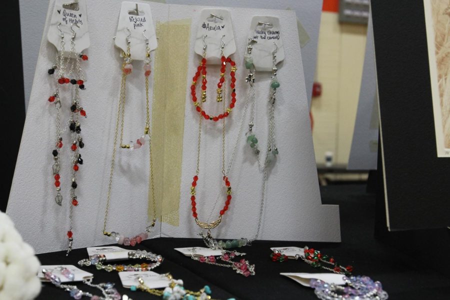 Jewelry was also sold at the art show, like these vivid necklaces created by  sophomore Rishi Tipparti.