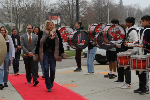 Gwynne Shotwell, COO of SpaceX, struts into Libertyville High School. She is welcomed with a red carpet and the LHS drumline.