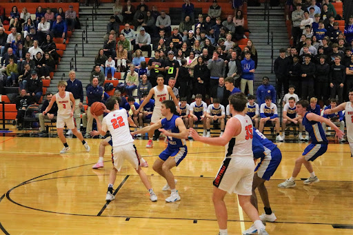 Guarded+by+a+Lake+Forest+player%2C+senior+Jack+Huber+%2822%29+clutches+the+ball+tightly%2C+formulating+%0Aa+play+to+take+it+to+the+basket%2C+while+seniors+Kaj+Sorensen+%283%29+and+Aidyn+Boone+%2840%29+move+into+position+in+the+background.+Huber%2C+a+strong+shot+with+a+penchant+for+three-pointers%2C+played+an+outstanding+game+for+the+Cats.