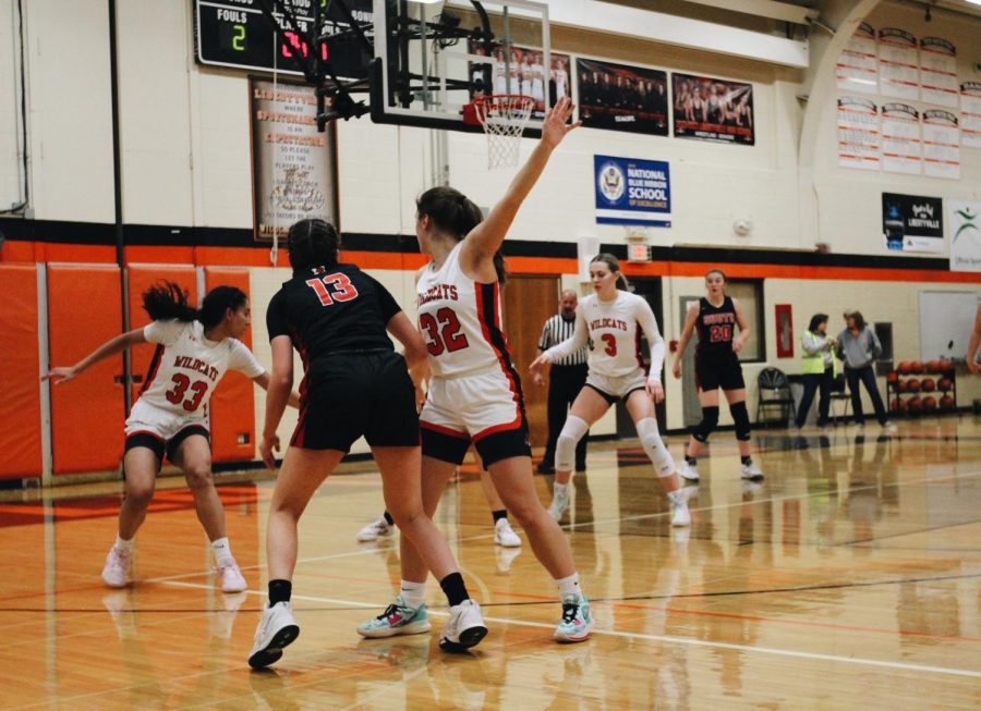 Junior Rachel Rule (32) stands tall, defending junior Ava Blagojevich (13), Maine South’s leading 3-point shooter.