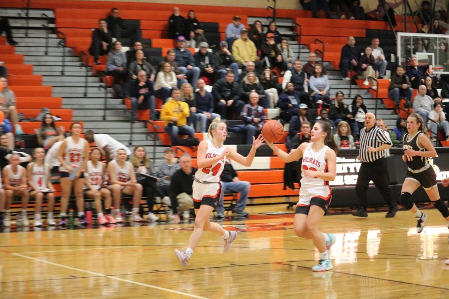 Juniors Kate Rule (24) and Rachel Rule (32) race down the court as Rachel prepares her shot that would officially tie up the game for the first time. “I had full confidence in my team,” explained Kate. “We got down big early, but I knew we could always find a way to win and we did.”
