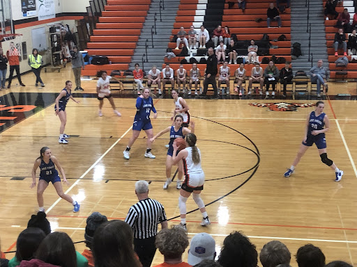 Junior Maddy Kopala (42) readies herself at the three-point line, seizing the opportunity to make a shot for her team. Kopala, who had nine points from three-pointers during the game, pulled through and made the basket.