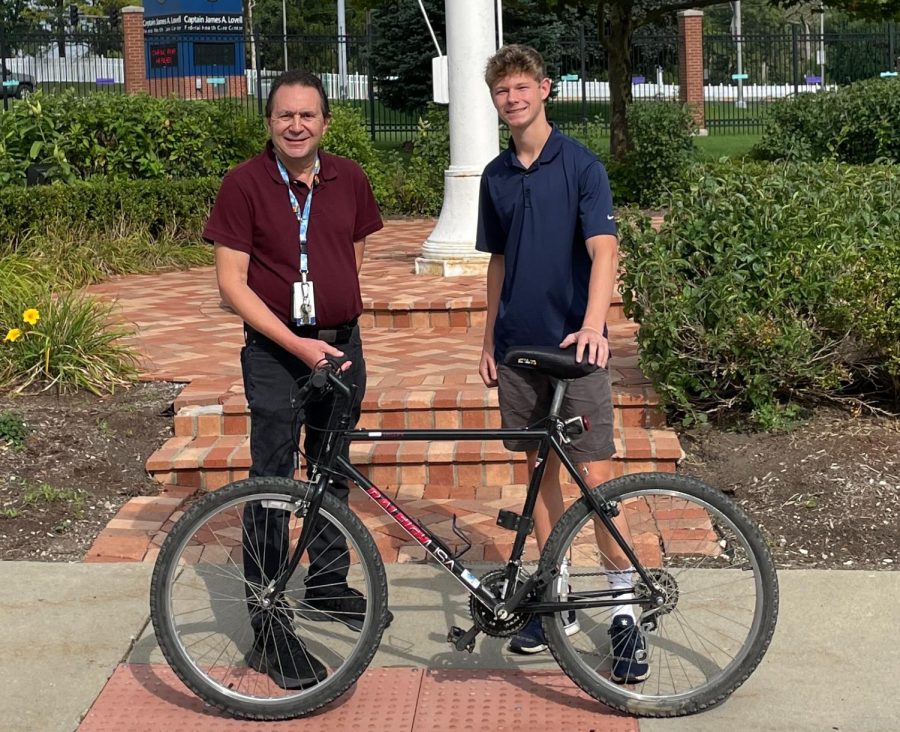 Gregory Mavromatis, a social worker at the Federal Health Care Center in North Chicago (left) and Chase Houser stand proudly with a bike he refurbished and donated.