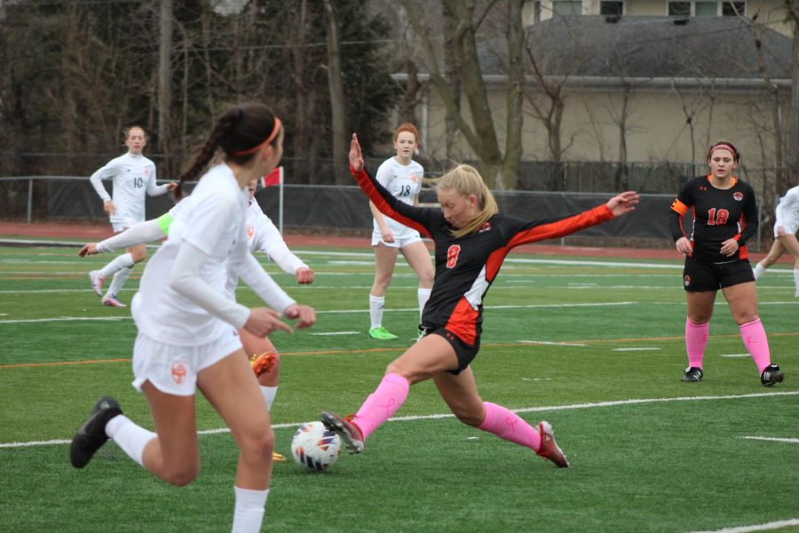 Junior Erin Kelly (8) lunges for the ball, keeping the Huskies from getting a goal against the home team.
