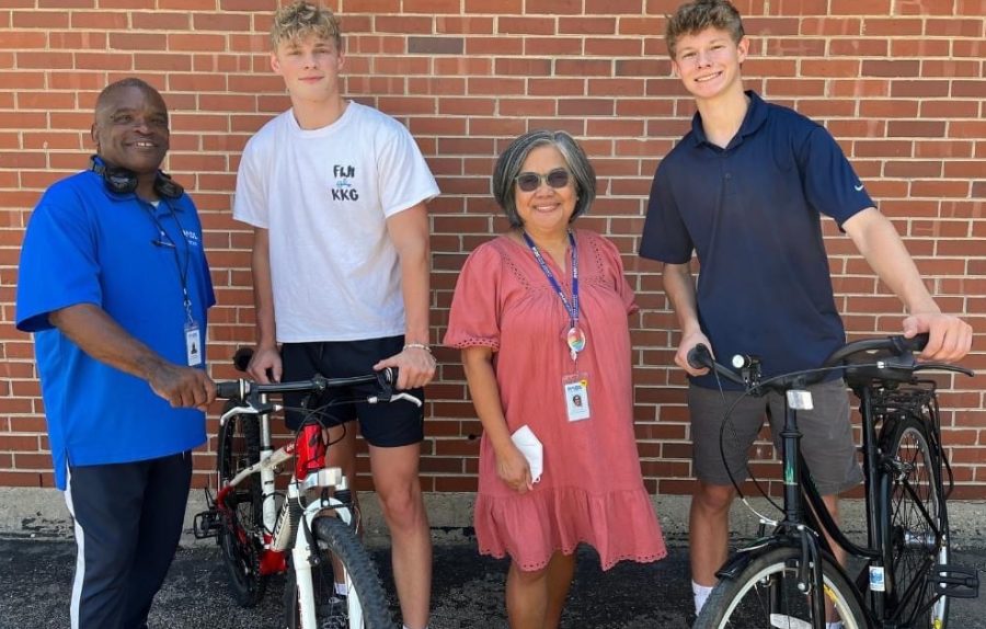 James, an admin at PADS (left), alumnus Cole Houser, Claress, another admin at PADS, and senior Chase Houser pose with bikes he donated to PADS. (Photo provided by Chase Houser). 
