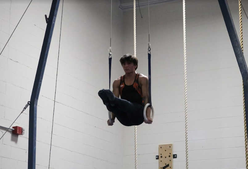 Senior Josh Jenkinson, who has been part of the boys gymnastics team for three years, remains poised and calm during an L-sit, earning a 6.40 on the still rings for the varsity team. 