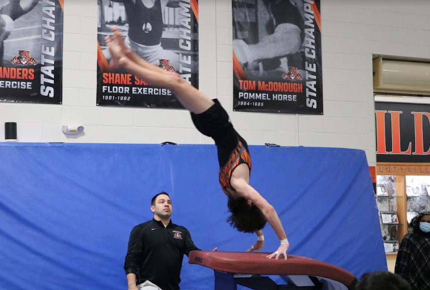 Sophomore Avery Wells propels himself off of the vault, scoring a 6.5 for the varsity team.
