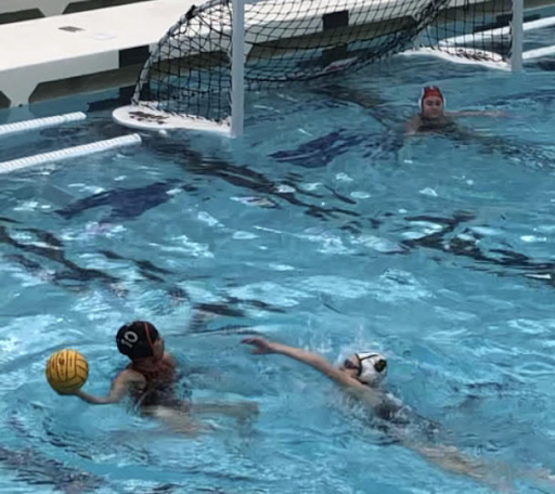 Deep in Elk Grove territory, senior Abby Maglio (10) handles the ball in preparation for a pass, facing pressure from a Grenadier. Maglio and others were instructed not to score to avoid running up the score and instead use the opportunity to work on ball movement and passing.