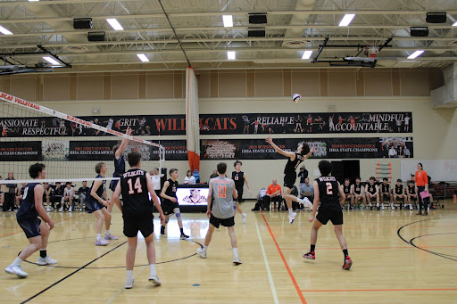 Senior Aleks Slesers (6) jumps up to smash a shot into the backline of New Trier’s defense.