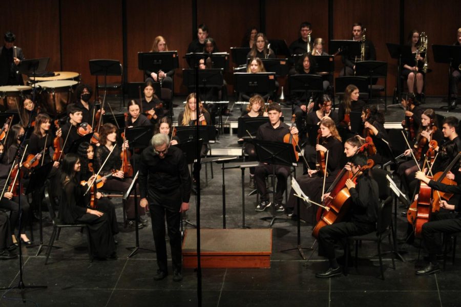 Mr. Marino bows to the audience before starting the performance of the symphony orchestra. Marino said that he can tell that the students really care. “They really lock in to the moment and are really focused on doing things well,” he said.  