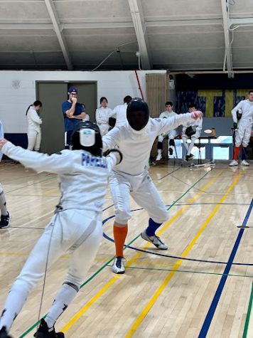Hugh Weathey fences against another epee fencer from an opponent school at Glenbrook South. Fencing tournaments happen every other weekend at various locations in the midwest. 