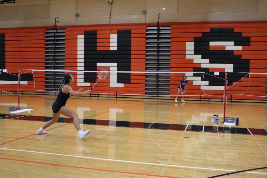 Mia Plunkett plays a singles game against a Warren opponent.