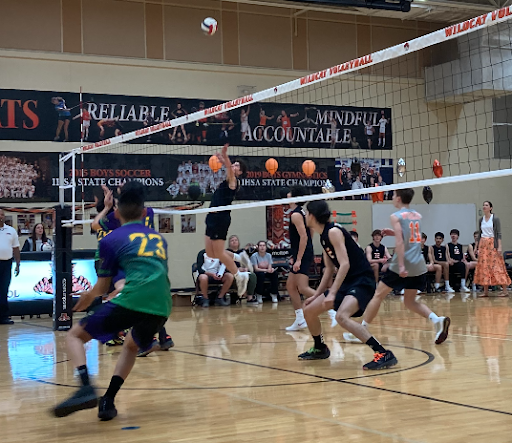 Senior Luis Correa (2) jumps up to spike the ball against Waukegan’s defense.