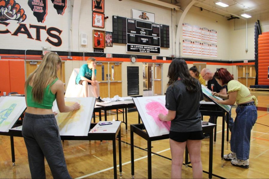 AP Portfolio students draw from a live model, Hank Brown, son of choir instructor Dr. Brown and dance teacher Mrs. Brown. Different props and live models were used throughout the day for the life drawings, including art teacher Mr. Ray Gossell. 