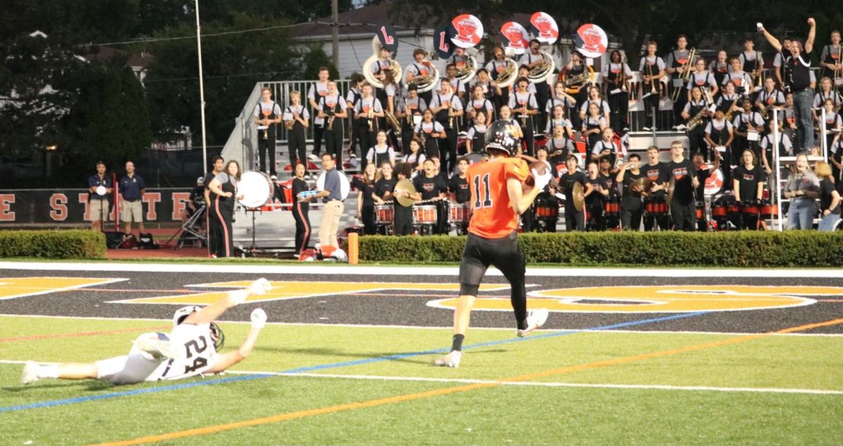 Junior Stevan Gavric (11) scores Libertyville’s first touchdown of the game, much to the home crowd’s approval. Lemont threw everything they had at the Wildcats, scoring on the very first play, but Gavric’s rush to the end zone marked the turning point for the home team.