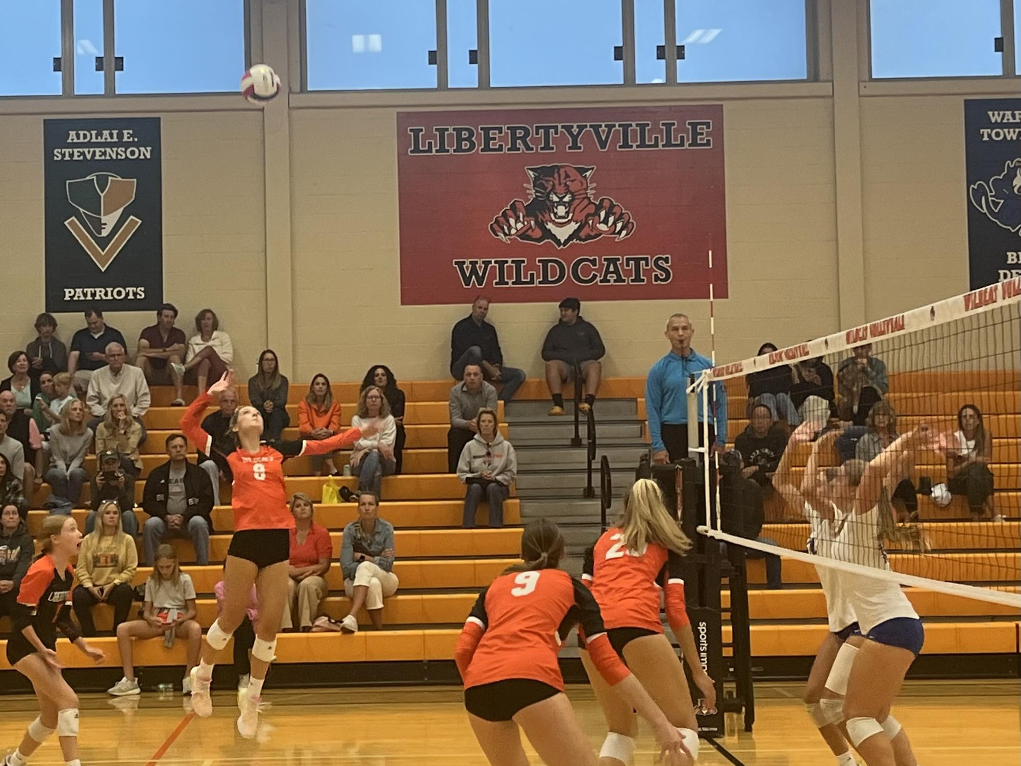 In a second set against the Lake Forest Scouts, senior Stella Meyer (8) springs into the air to spike the ball back over the net. Meyer, alongside other players such as senior Hannah Fleming (17), contributed to a large number of kills for the home team.