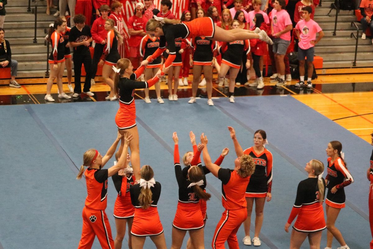 The LHS cheer team performs a stunt to start the assembly off strong. This was one of many stunts the cheerleaders performed in a full routine themed to this years homecoming theme: Sweet Homecoming Chicago.
