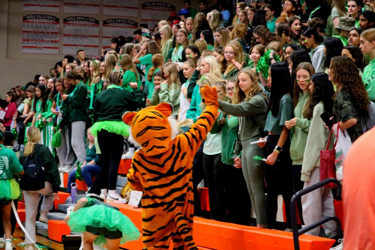 The class of 2027 gathers in the main gym bleachers before the assembly begins. The freshmen are full of spirit, dressed in green ready to have their chance at the spirit cup.
