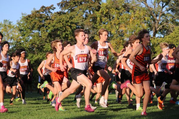 With three miles of course ahead, including a grueling hill-climbing finish, the boys cross country team shoots off the starting line to begin their journey on the Adler Park course – the team’s home turf. Such runners as senior Jack Barry take the starting steps in stride to secure strong finishes.