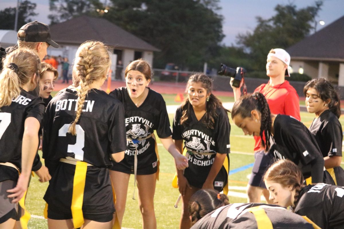 Senior Ronnie Leonard hypes up her team before the start of the first round of the Powder Puff game. Two players from her team – seniors Brianna Valdez and Lily Botten  – scored two touchdowns for the black team.