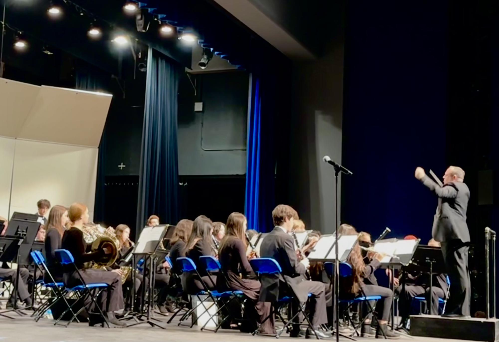 The Wind Symphony performs “Hymn for US” in the Highland Park High School Auditorium. James Stephenson, the composer, said, “[Through this piece], I wanted to reflect on the solemn events that took place, but also to express the hope and the strength of the community that was evident to any of those who were watching the news.” 
